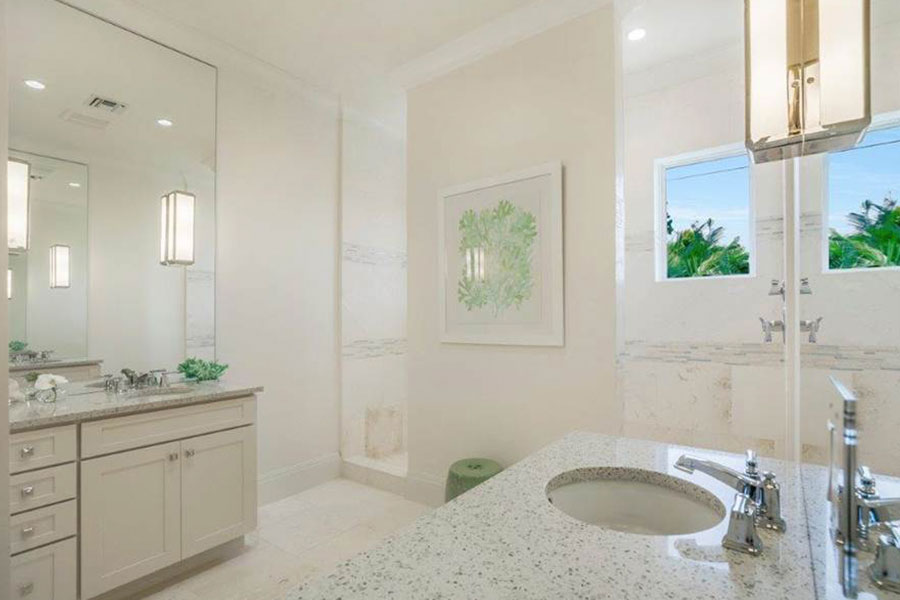 Bright, white master bathroom with unique walk-in shower designed by Scholten Construction