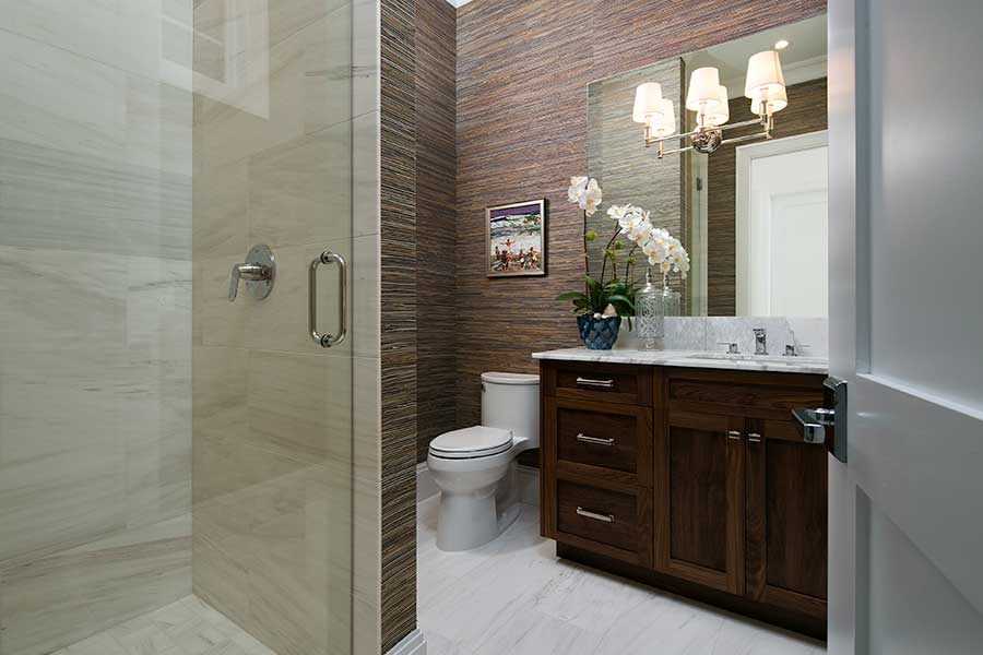 Guest bathroom with custom cabinetry and custom shower constructed by Scholten Construction Custom Home Services