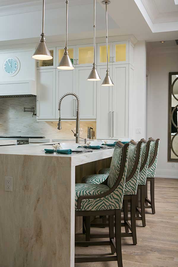 Kitchen island with custom selected bar stools and lighting from Scholten Construction interior design services